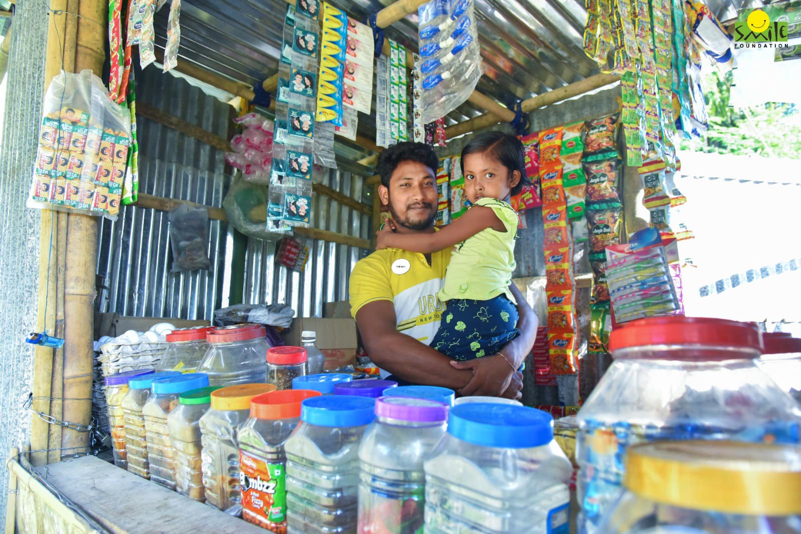 A shopkeeper with his girl child in India